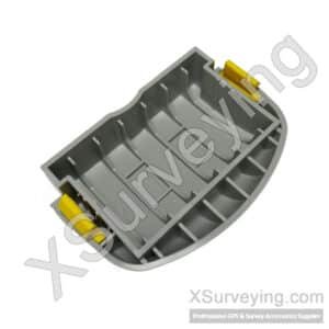 Replacement Battery Door For Trimble Gnss Receivers A Grey Plastic Battery Door Component For A Trimble R4 Or R6 Gnss Receiver, Featuring Yellow Locking Tabs.