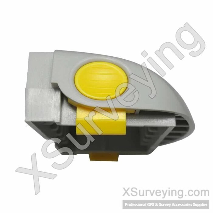 Trimble R4 and R6 GNSS Receiver Battery Door A grey plastic battery door for a Trimble GNSS receiver featuring a prominent yellow circular release button and a yellow latch mechanism.